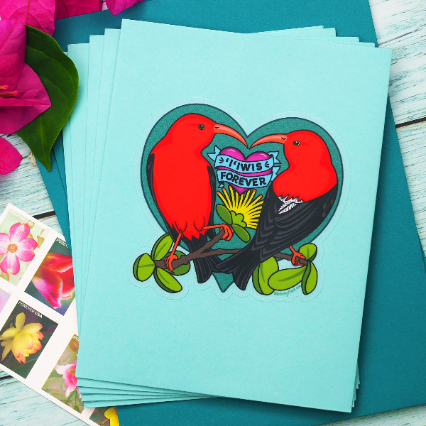 Heart shaped sticker illustration of two native Hawaiian honeycreepers, iiwi, almost touching beaks with text that reads "‘i’iwis Forever."